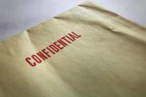 A yellow envelope stamped with the word confidential in red ink.